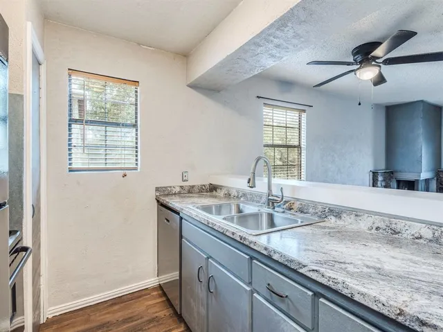 a bathroom with a granite countertop sink a large mirror and vanity