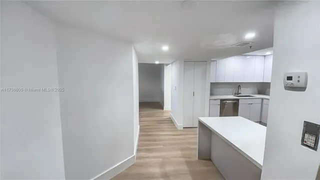a view of a kitchen with a sink