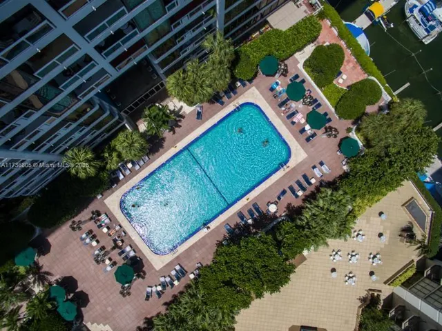 an aerial view of a house with swimming pool and outdoor space