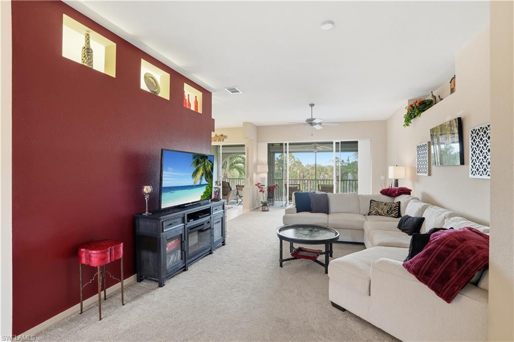 10871 Crooked River Road, Unit 202 Estero, FL 34135 - Photo 3 of 46 a living room with furniture and a flat screen tv