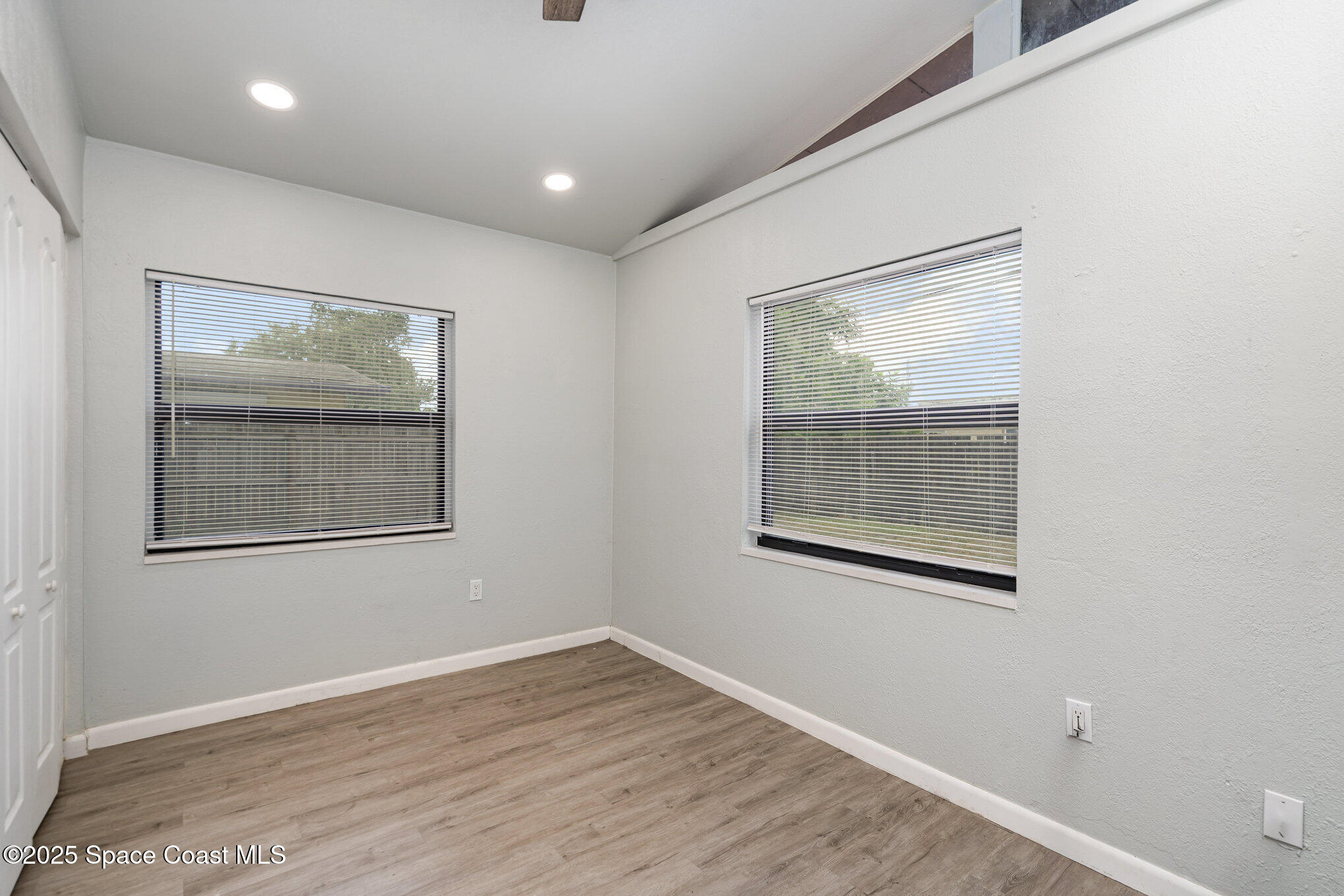 2158 Laden Road Melbourne, FL 32935 - Photo 17 of 19 a view of an empty room with wooden floor and a window