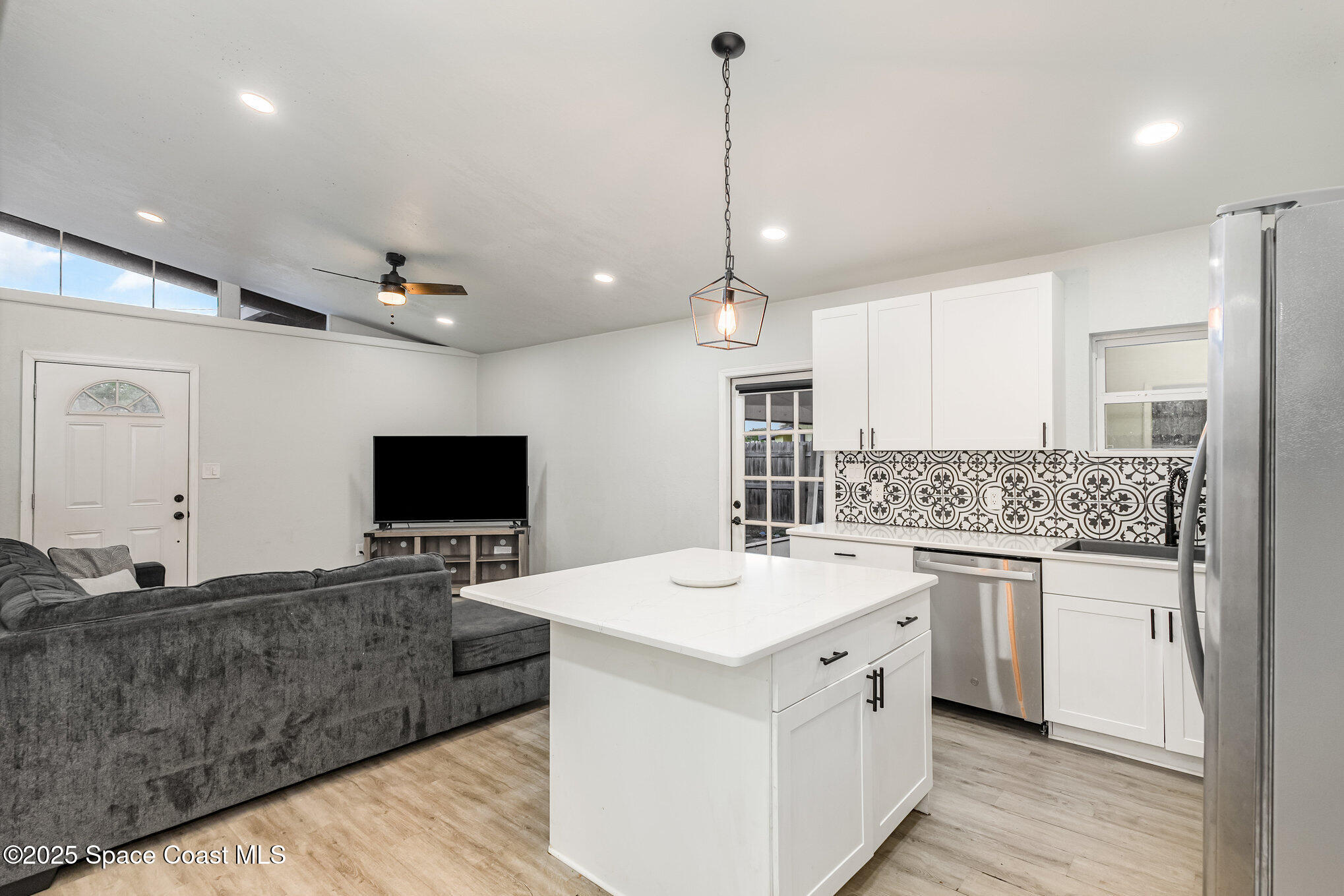 2158 Laden Road Melbourne, FL 32935 - Photo 9 of 19 a view of living room with granite countertop furniture and a flat screen tv