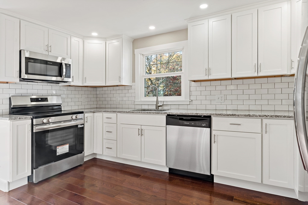 172 Gibbs Street Fall River, MA 02720 - Photo 15 of 29 a kitchen with granite countertop white cabinets stainless steel appliances and a sink