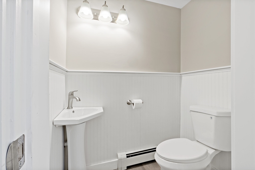 172 Gibbs Street Fall River, MA 02720 - Photo 19 of 29 a white toilet sitting next to a bathroom sink