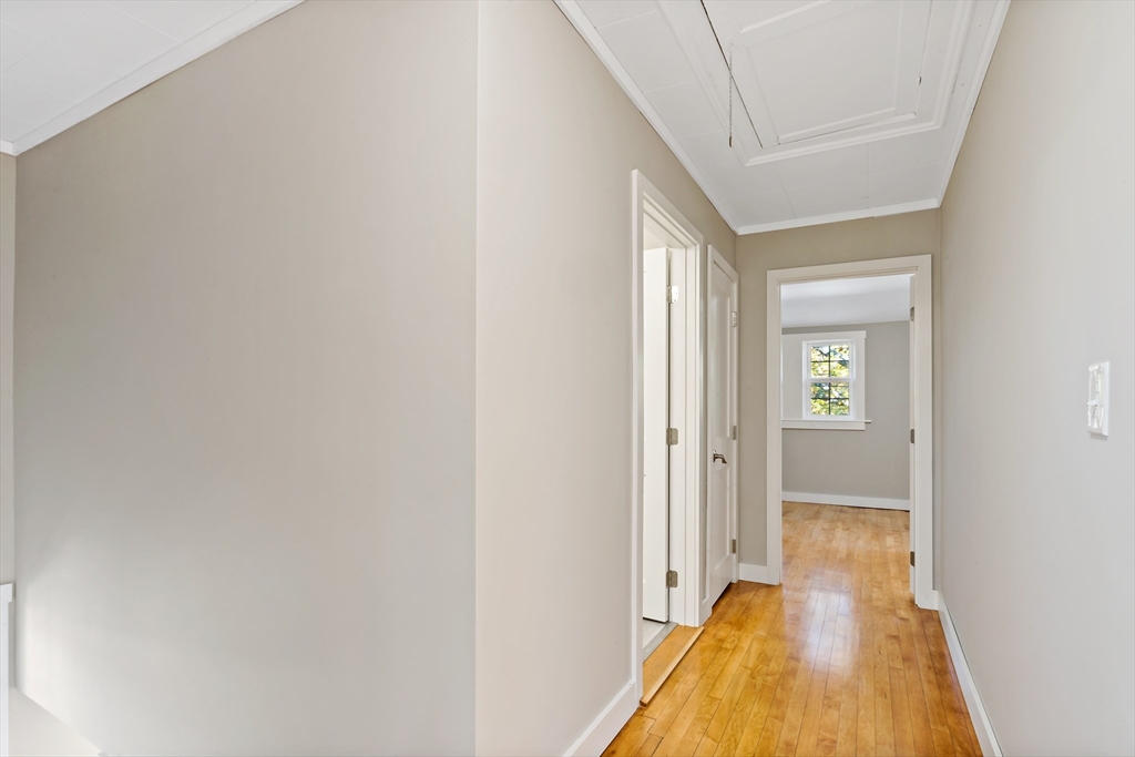 172 Gibbs Street Fall River, MA 02720 - Photo 25 of 29 a view of a hallway with wooden floor and a bathroom