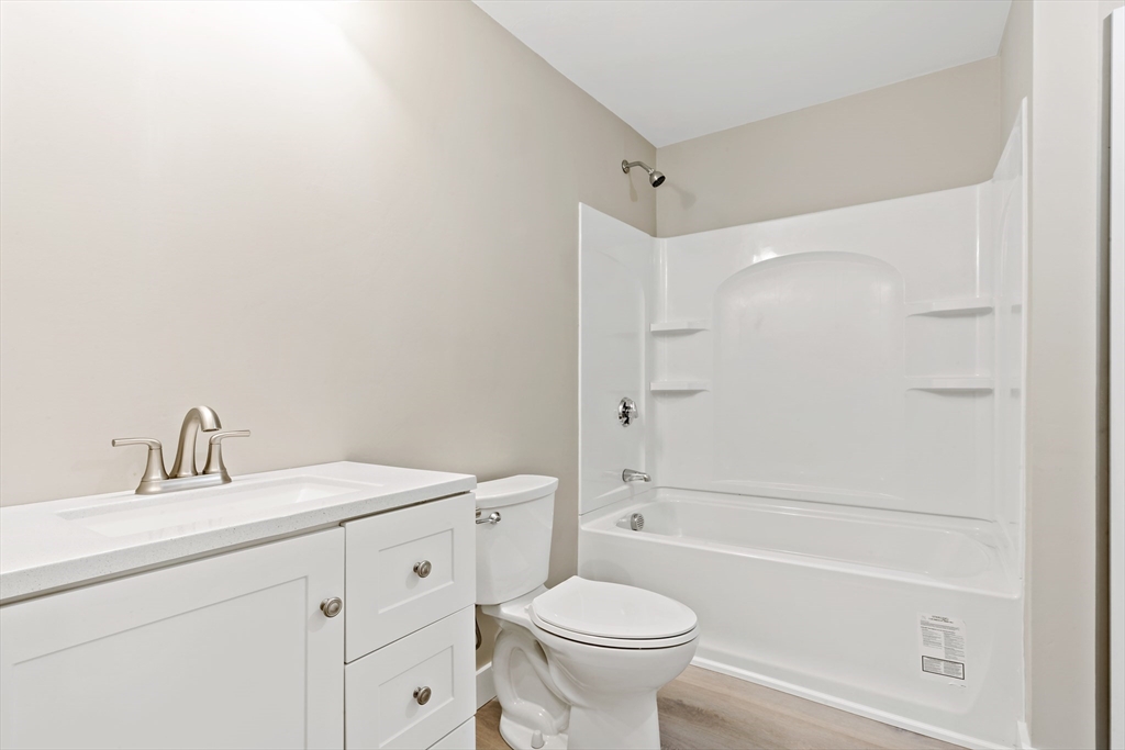 172 Gibbs Street Fall River, MA 02720 - Photo 26 of 29 a bathroom with a toilet a sink a mirror a bathtub and vanity