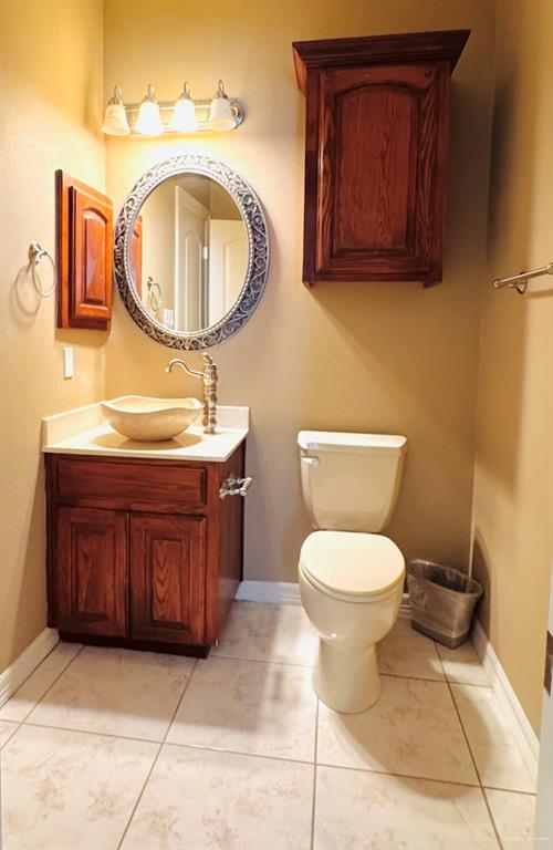 201 Thornwood Loop Rio Grande City, TX 78582 - Photo 18 of 25 a bathroom with a toilet sink and mirror