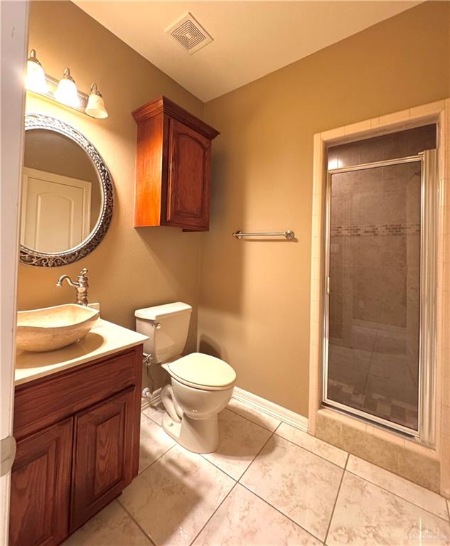 201 Thornwood Loop Rio Grande City, TX 78582 - Photo 19 of 25 a bathroom with a toilet sink and mirror