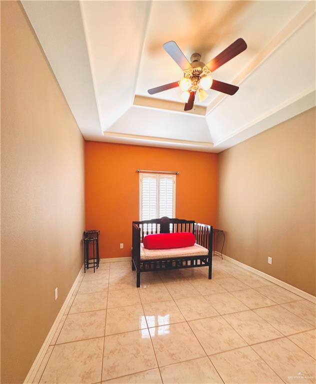 201 Thornwood Loop Rio Grande City, TX 78582 - Photo 20 of 25 a bedroom with a bed and a chandelier
