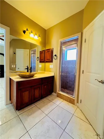 a bathroom with a granite countertop sink mirror and shower