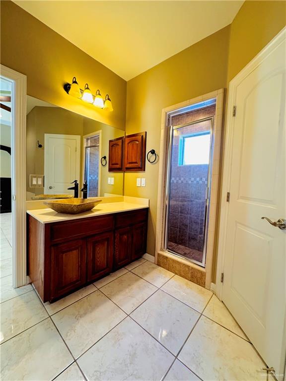 201 Thornwood Loop Rio Grande City, TX 78582 - Photo 22 of 25 a bathroom with a granite countertop sink mirror and shower