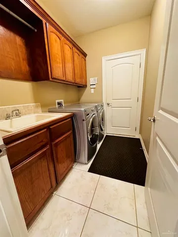 a utility room with sink dryer and washer