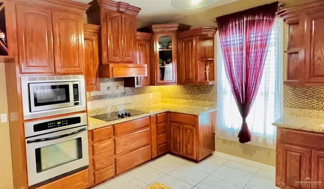 a kitchen with stainless steel appliances granite countertop a stove and a microwave