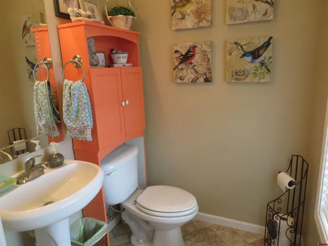a spacious bathroom with a double vanity sink a large mirror and a bathtub