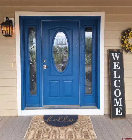 a view of an entryway door with wooden floor
