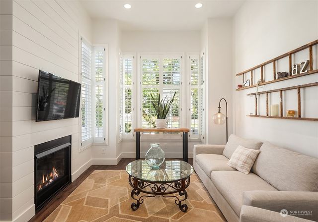 a living room with furniture fireplace and window