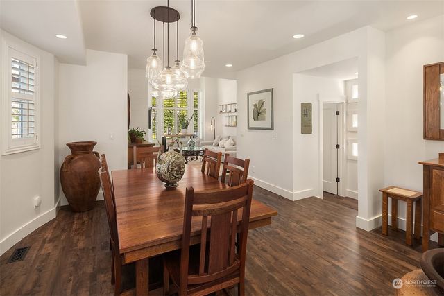 a view of a a dining room with furniture window and wooden floor