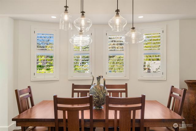 a view of a dining room with furniture and chandelier