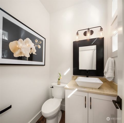 a bathroom with a toilet a sink and mirror