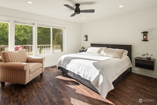 a bedroom with bed couch and window