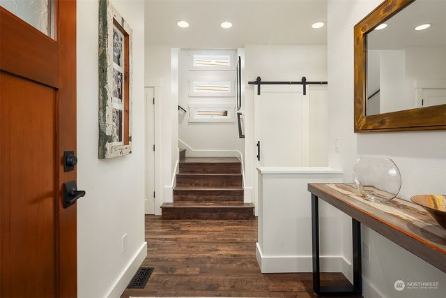 a view of entryway with furniture and wooden floor
