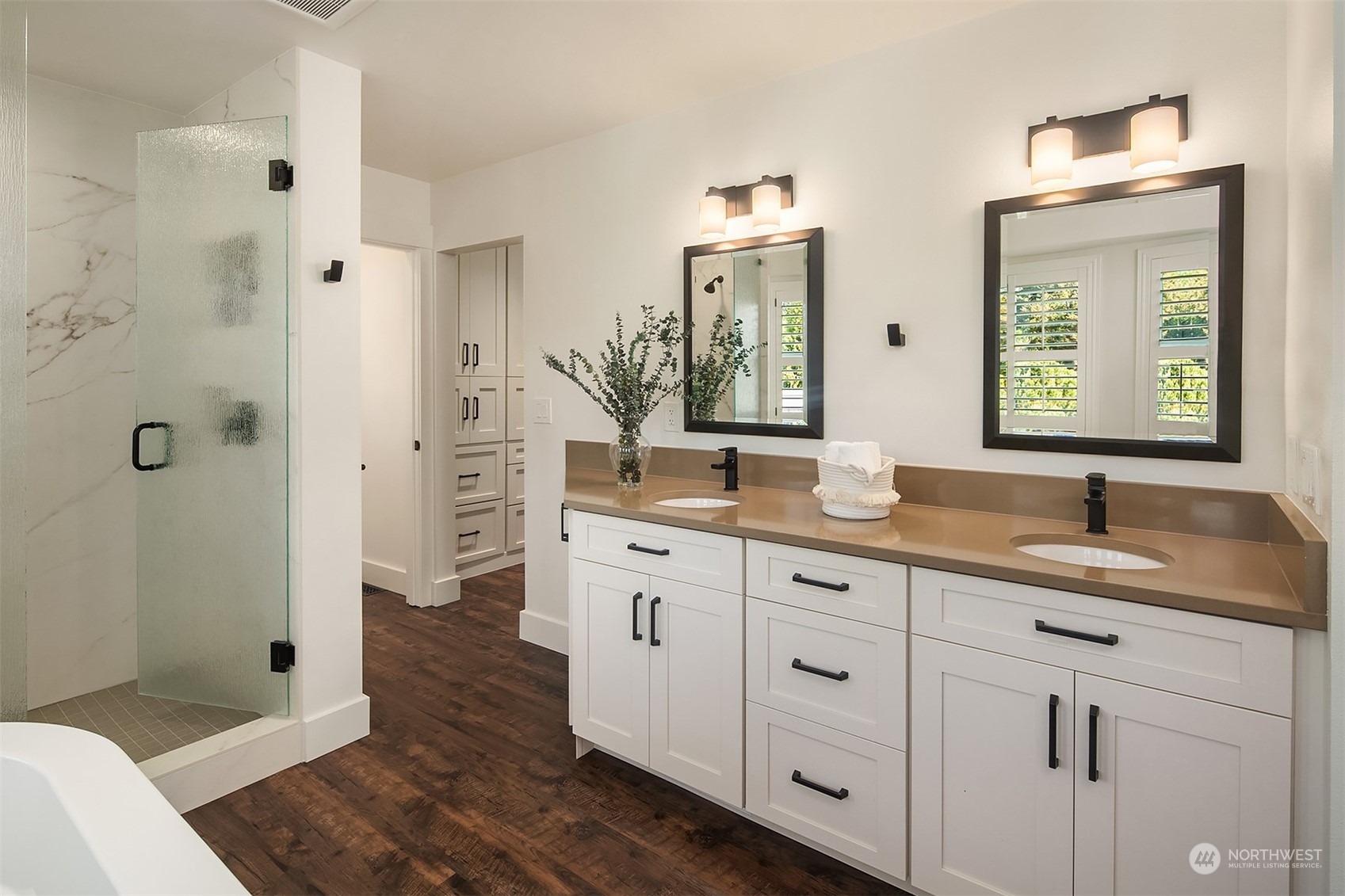 4401 Brygger Drive West Seattle, WA 98199 - Photo 21 of 36 a spacious bathroom with double vanity a mirror a bathtub and shower