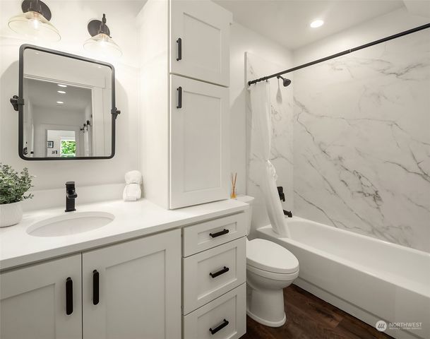 a bathroom with a toilet a sink and a bathtub