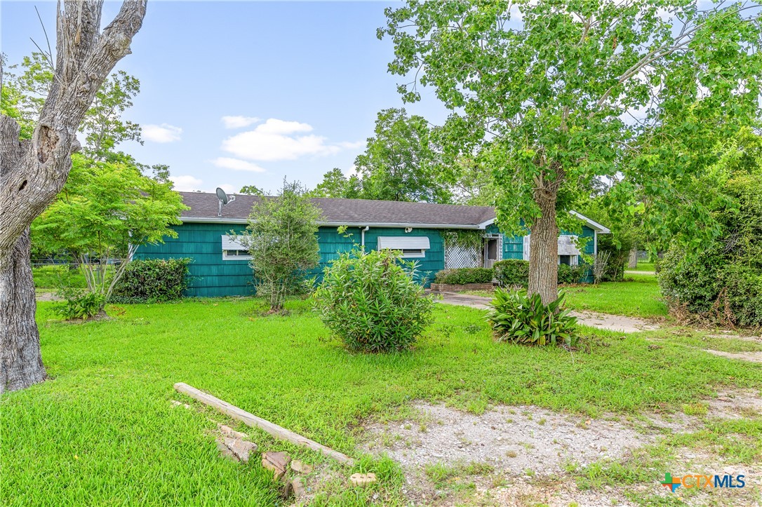 401 Kerr Street Edna, TX 77957 - Photo 3 of 23 front view of a house with a yard