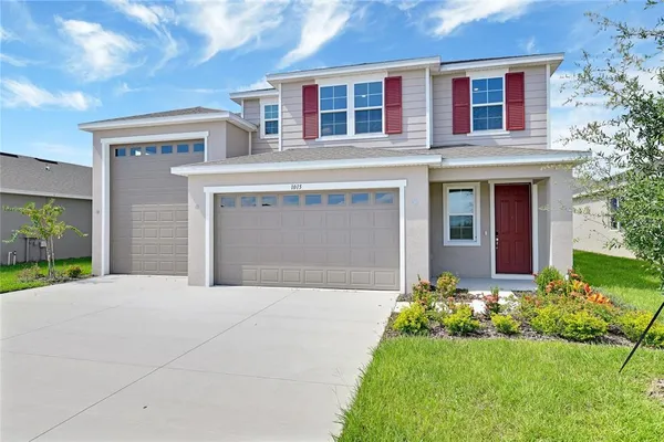 a front view of a house with a yard and garage