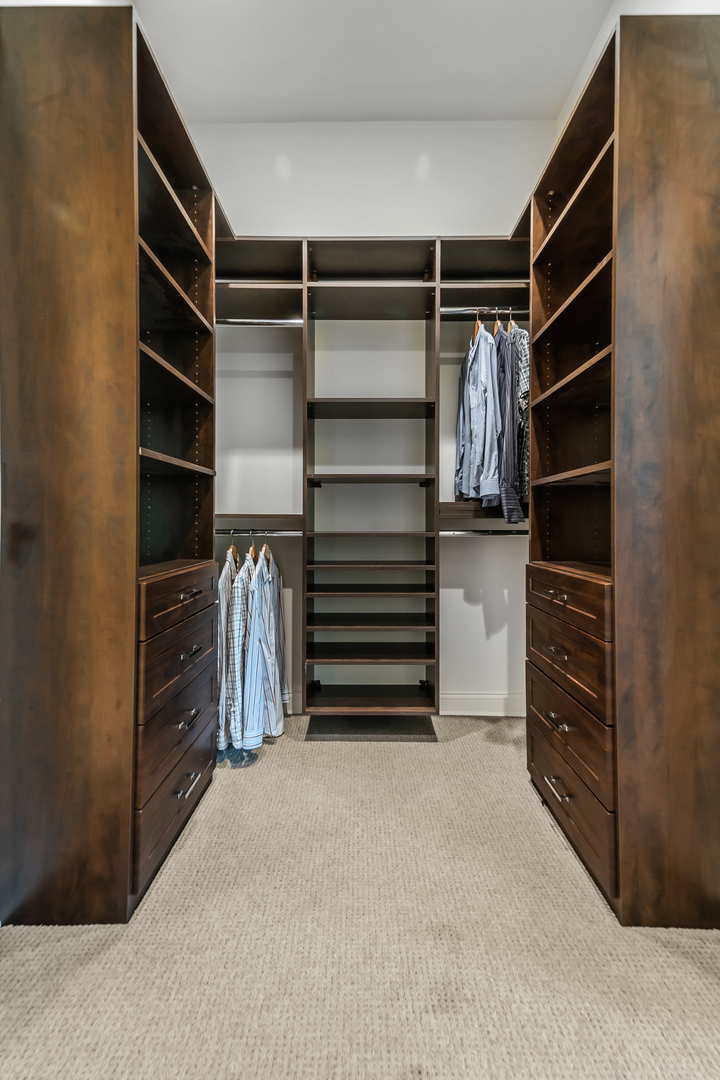 53 East Division Street Chicago, IL 60611 - Photo 34 of 78 a view of walk in closet with clothes and shoes