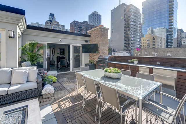 53 East Division Street Chicago, IL 60611 - Photo 60 of 78 a view of a patio with couches table and chairs and potted plants