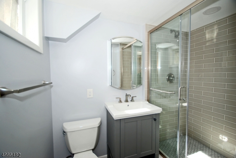 53 Summit Avenue Gillette, NJ 07933 - Photo 15 of 17 a bathroom with a toilet sink shower and mirror