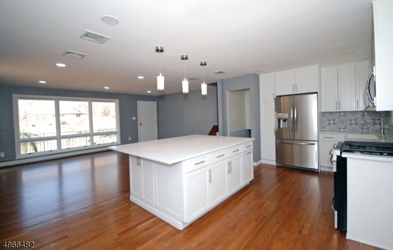 53 Summit Avenue Gillette, NJ 07933 - Photo 3 of 17 a large kitchen with a large counter top a sink stainless steel appliances and cabinets