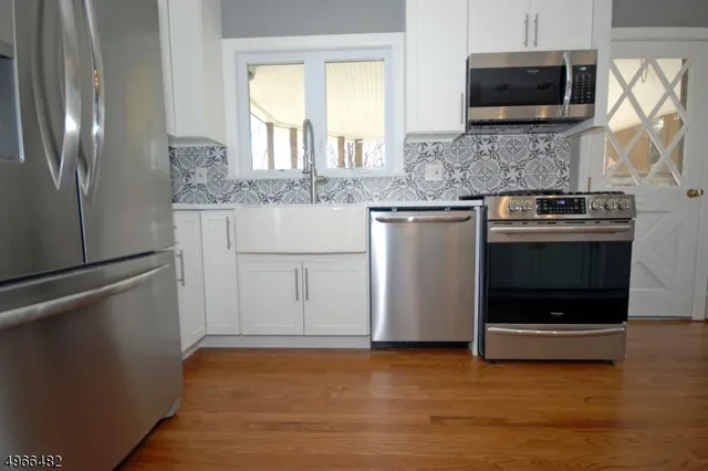 a kitchen with stainless steel appliances granite countertop a sink and a granite counter tops