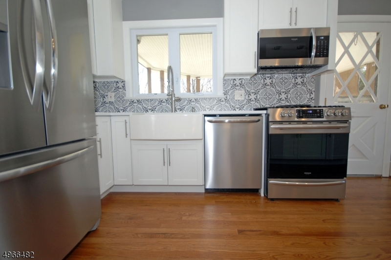 53 Summit Avenue Gillette, NJ 07933 - Photo 4 of 17 a kitchen with stainless steel appliances granite countertop a sink and a granite counter tops