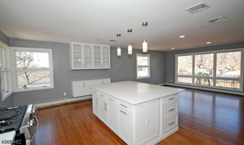 53 Summit Avenue Gillette, NJ 07933 - Photo 6 of 17 a kitchen that has a sink a stove and wooden floor