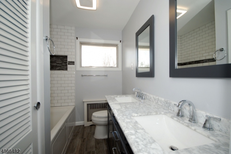 53 Summit Avenue Gillette, NJ 07933 - Photo 7 of 17 a bathroom with a granite countertop sink a toilet a mirror and shower