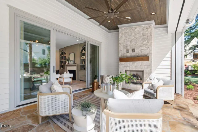 a dining room with wooden floor a chandelier a wooden table and chairs
