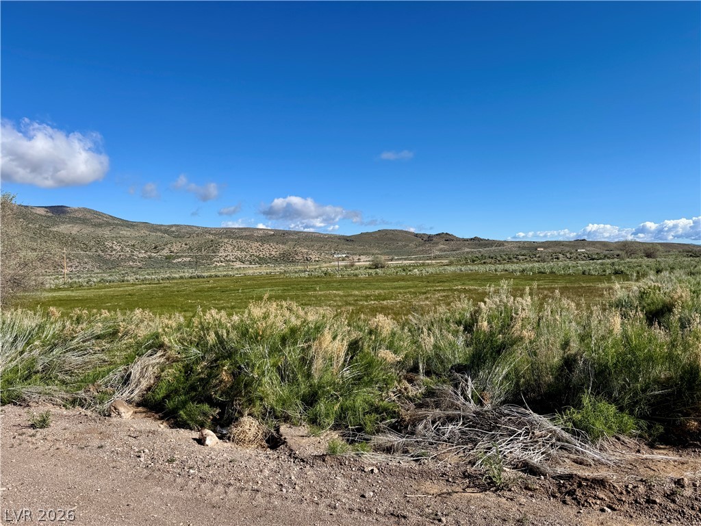 9393 North 93rd Highway Caliente, NV 89008 - Photo 33 of 41 A sprawling meadow framed by rolling hills, offering vast, unimpeded vistas.