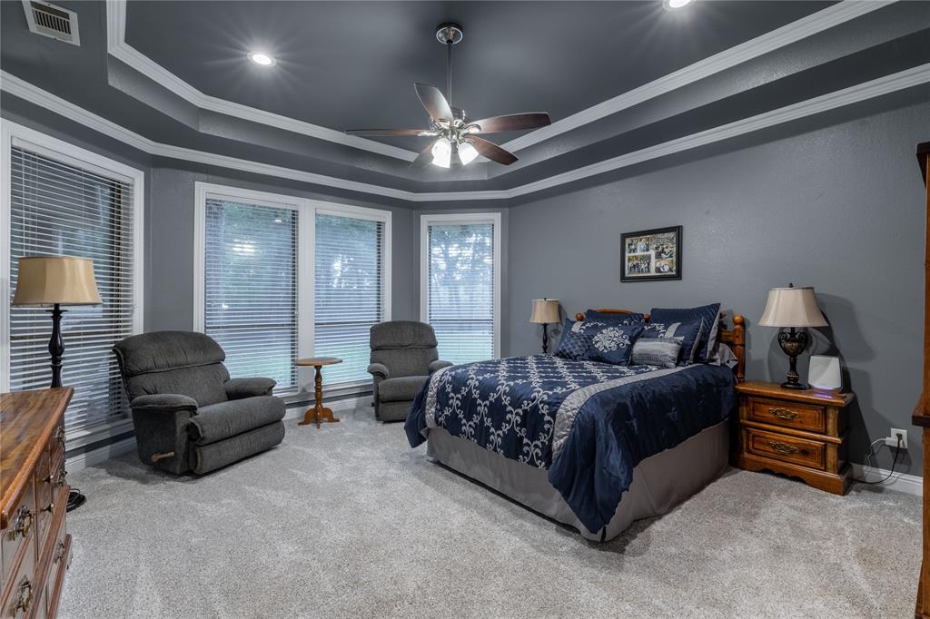 320 Rustic Oaks Road Combine, TX 75159 - Photo 22 of 40 Bedroom with carpet, a tray ceiling, ornamental molding, recessed lighting, and ceiling fan