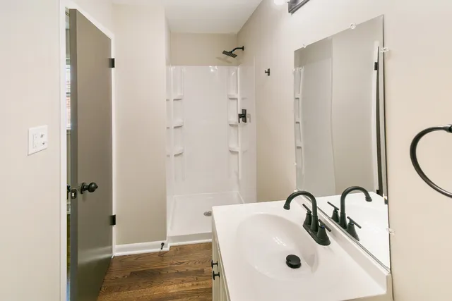 a bathroom with a sink and shower