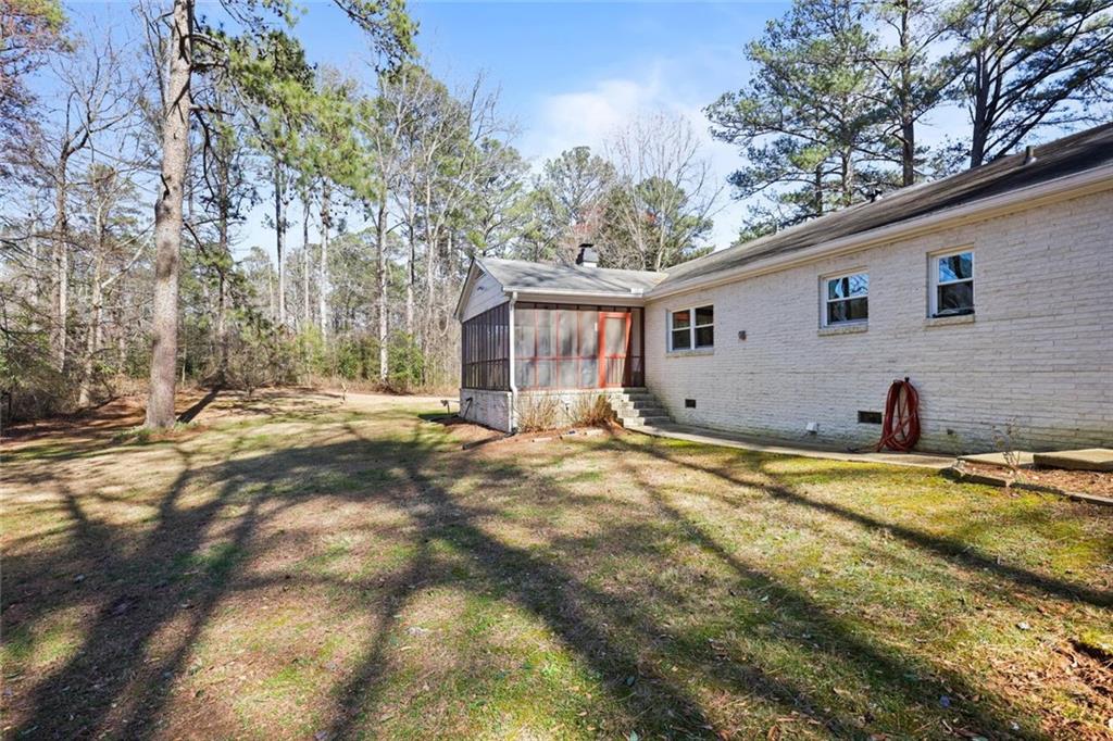 4505 Cochran Mill Road Fairburn, GA 30213 - Photo 30 of 36 a view of a house with backyard and trees