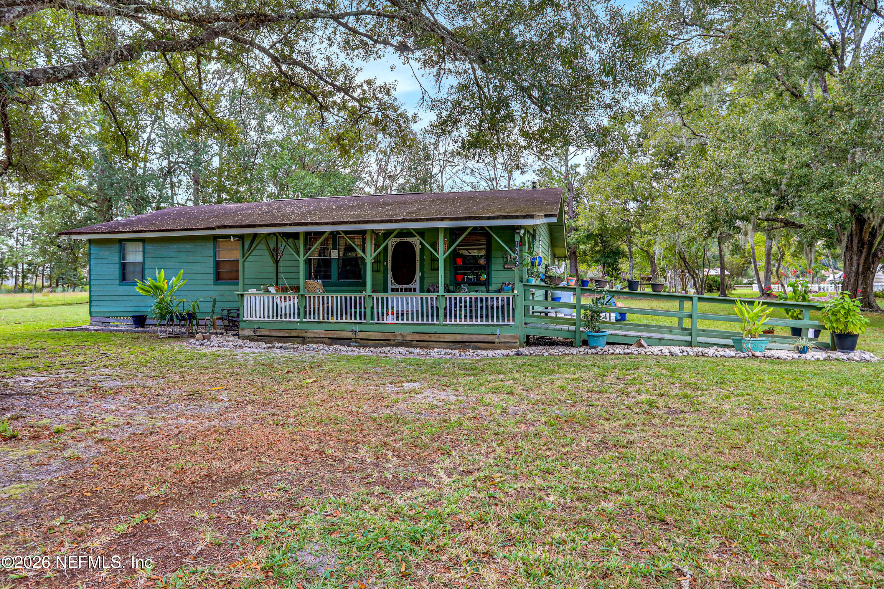 a front view of house with yard and green space