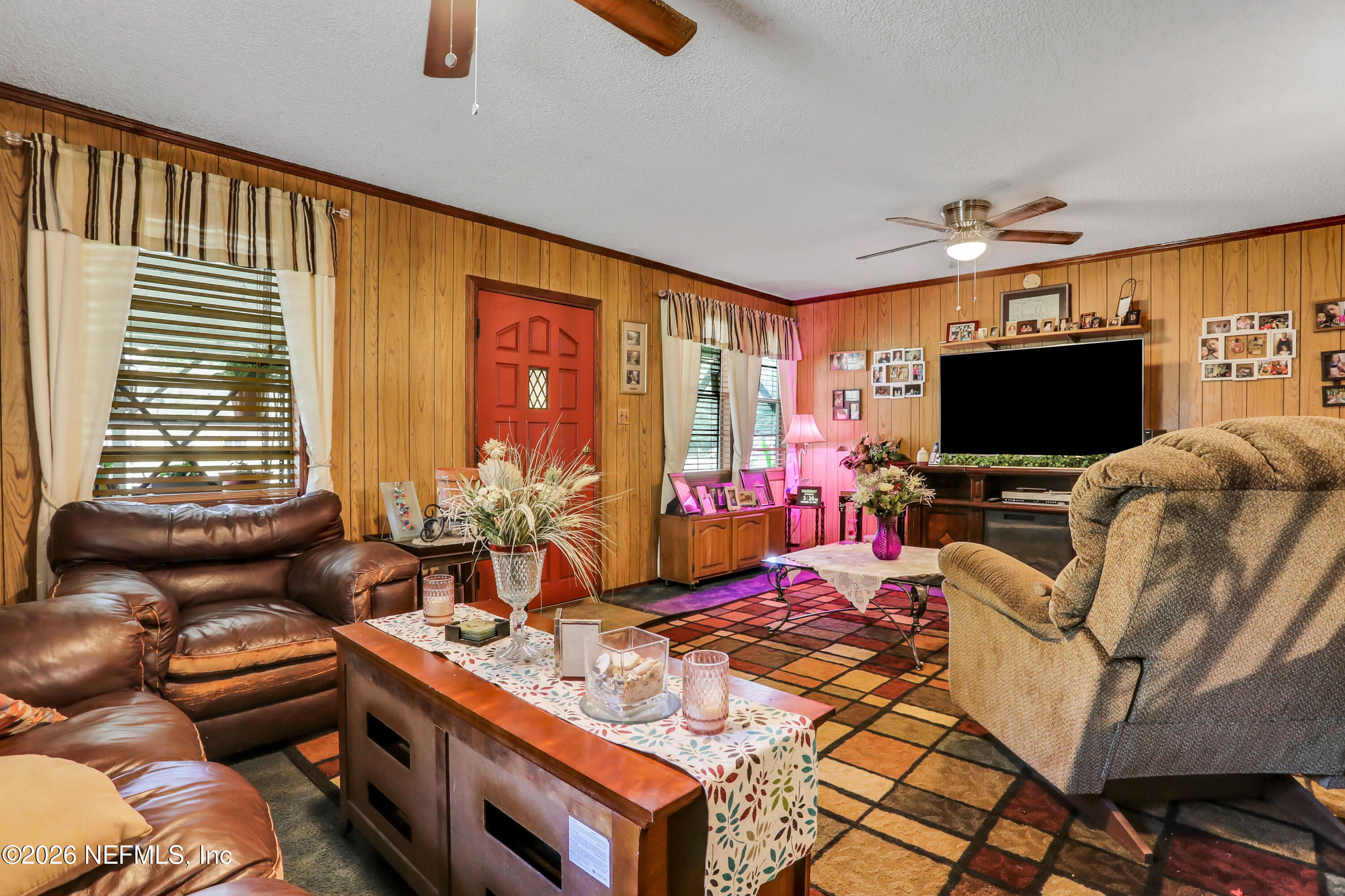 1702 Balboa Lane Middleburg, FL 32068 - Photo 7 of 31 a living room with furniture and a flat screen tv