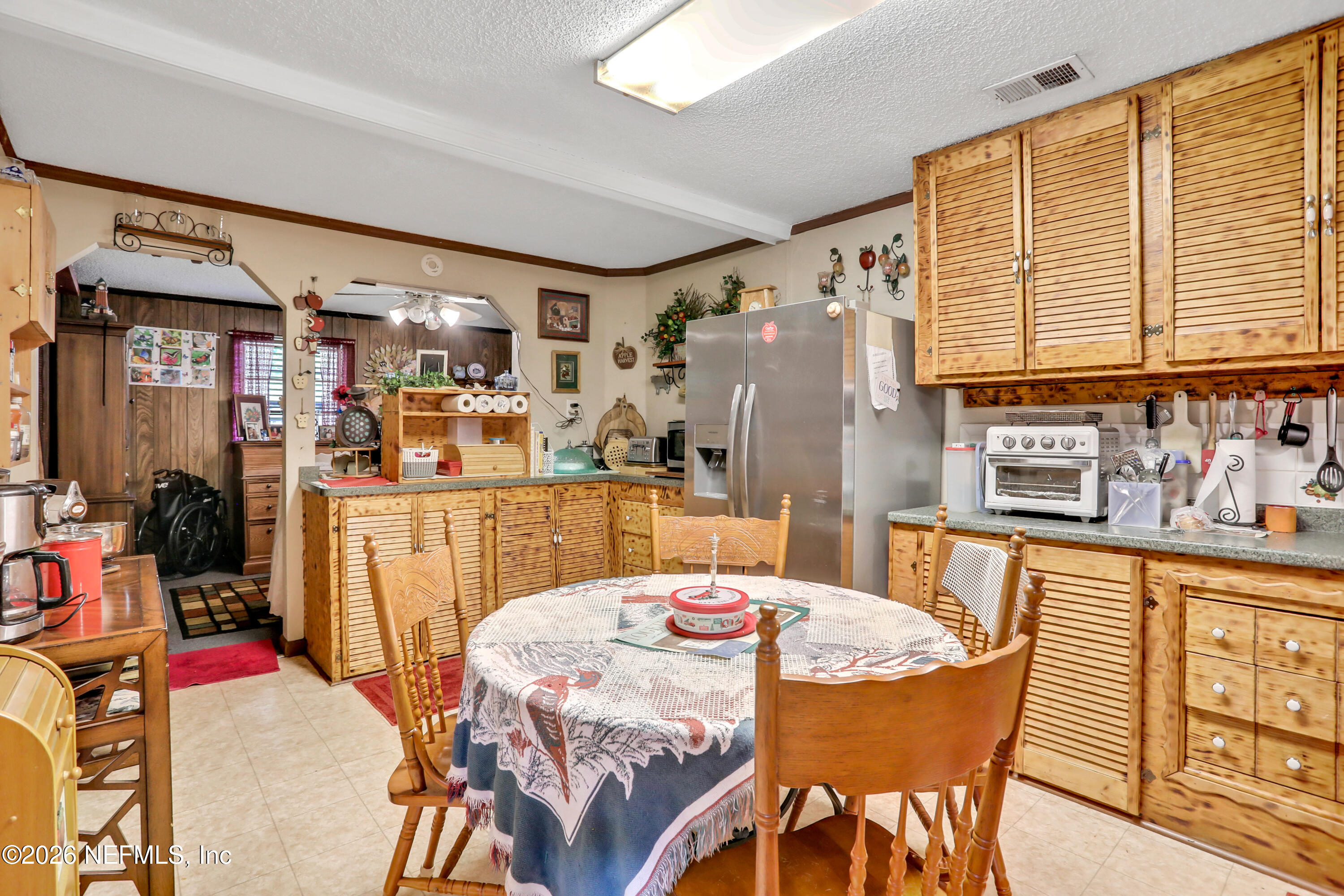 1702 Balboa Lane Middleburg, FL 32068 - Photo 10 of 31 a dining area with stainless steel appliances kitchen island granite countertop furniture and a kitchen view
