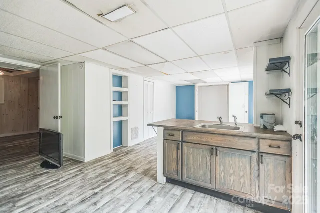 a spacious bathroom with a granite countertop sink a toilet and a mirror