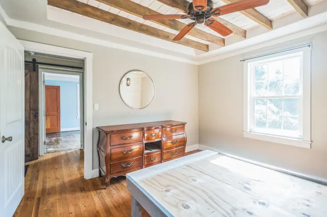 a view of a room with furniture and wooden floor