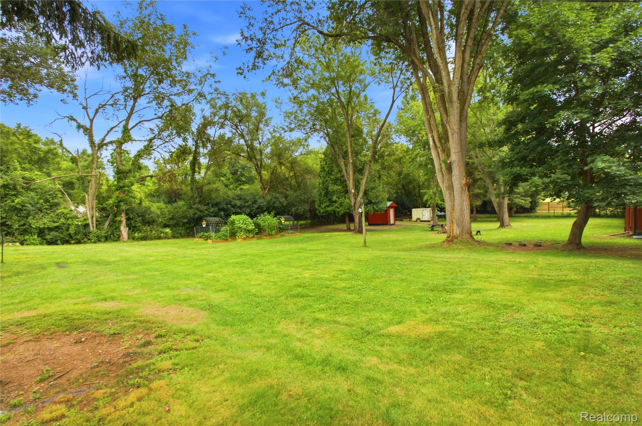 4945 Miller Road Ann Arbor, MI 48103 - Photo 39 of 42 Expansive green lawn with mature trees and a red shed