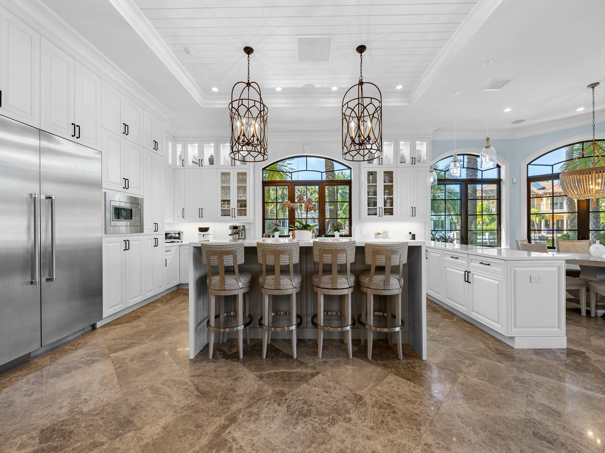 2319 Northeast 28th Street Lighthouse Point, FL 33064 - Photo 12 of 59 a large kitchen with a table and chairs