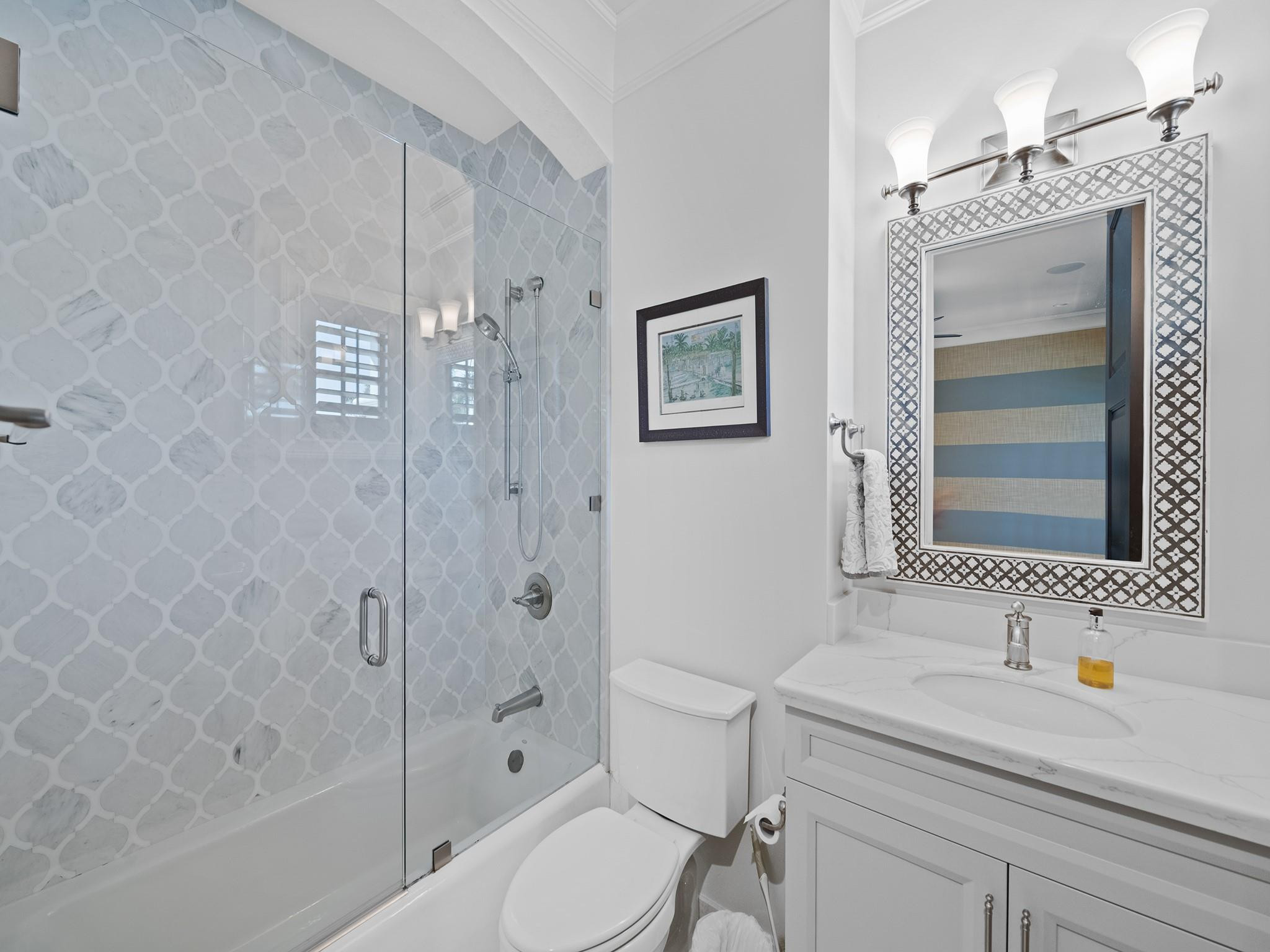 2319 Northeast 28th Street Lighthouse Point, FL 33064 - Photo 42 of 59 a bathroom with a sink a toilet and shower